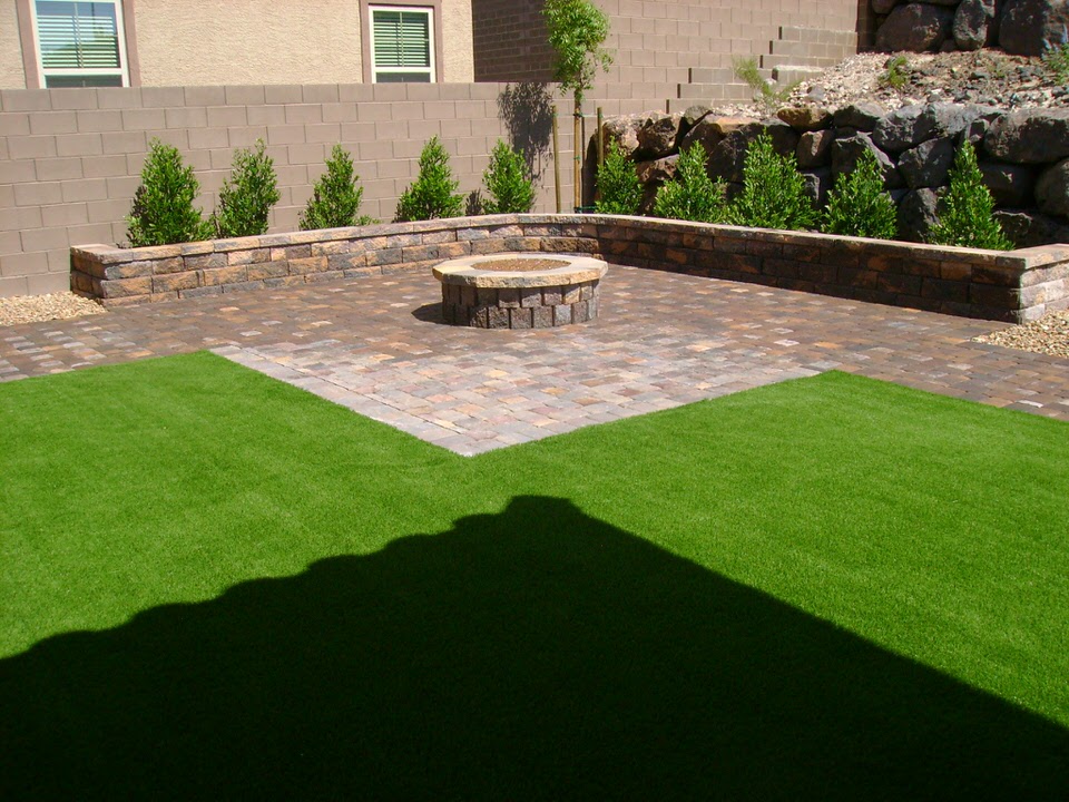 stone paving and grass with a small brick divider