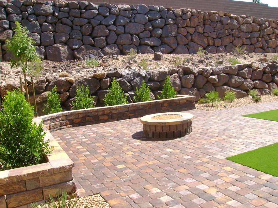 backyard with stone paving and small rock wall