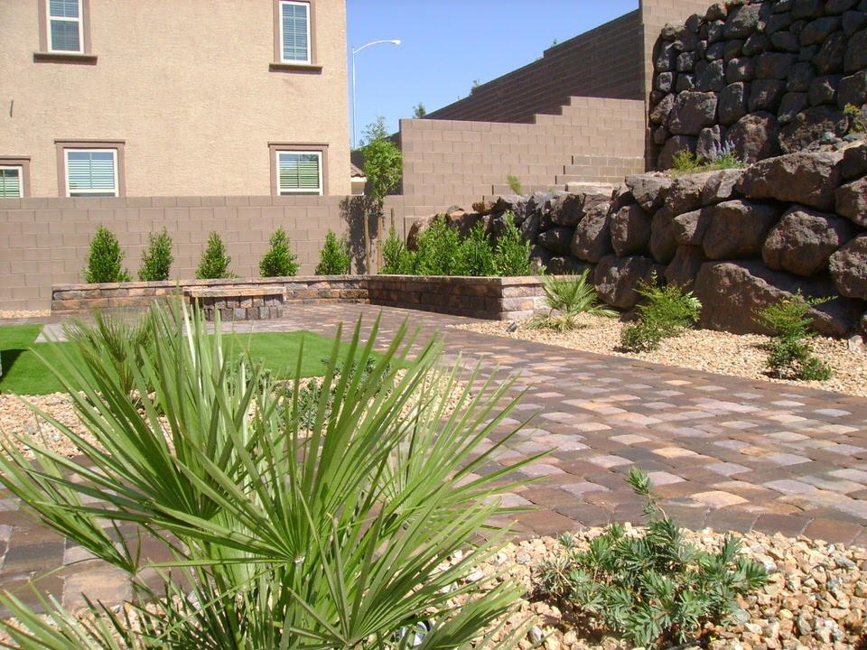 yard with rocks, small plants and stone paving