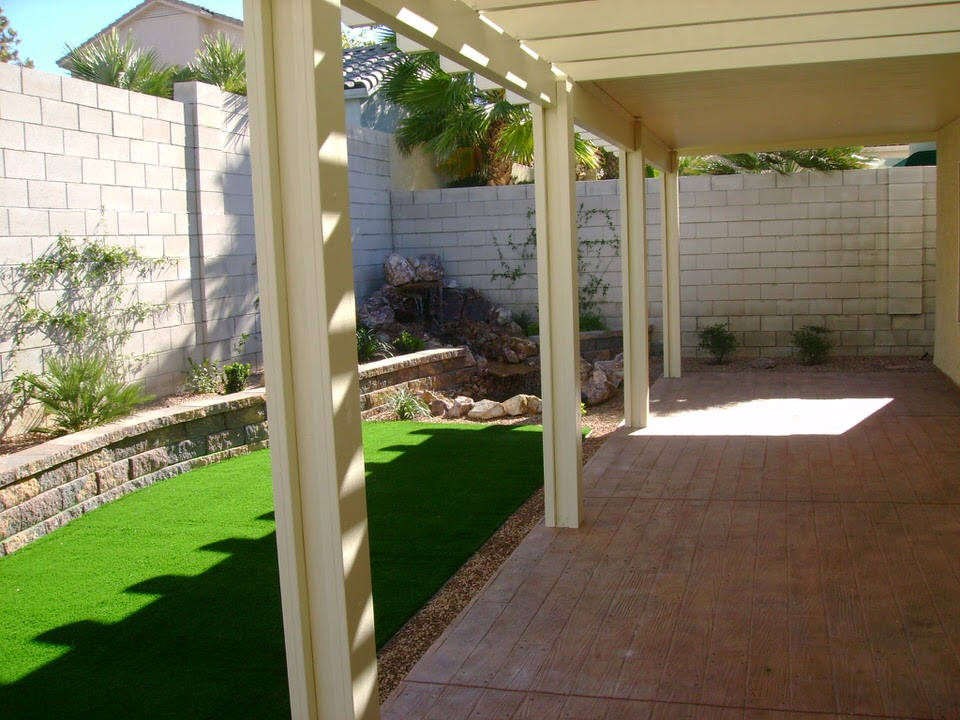 backyard with grass and a patio