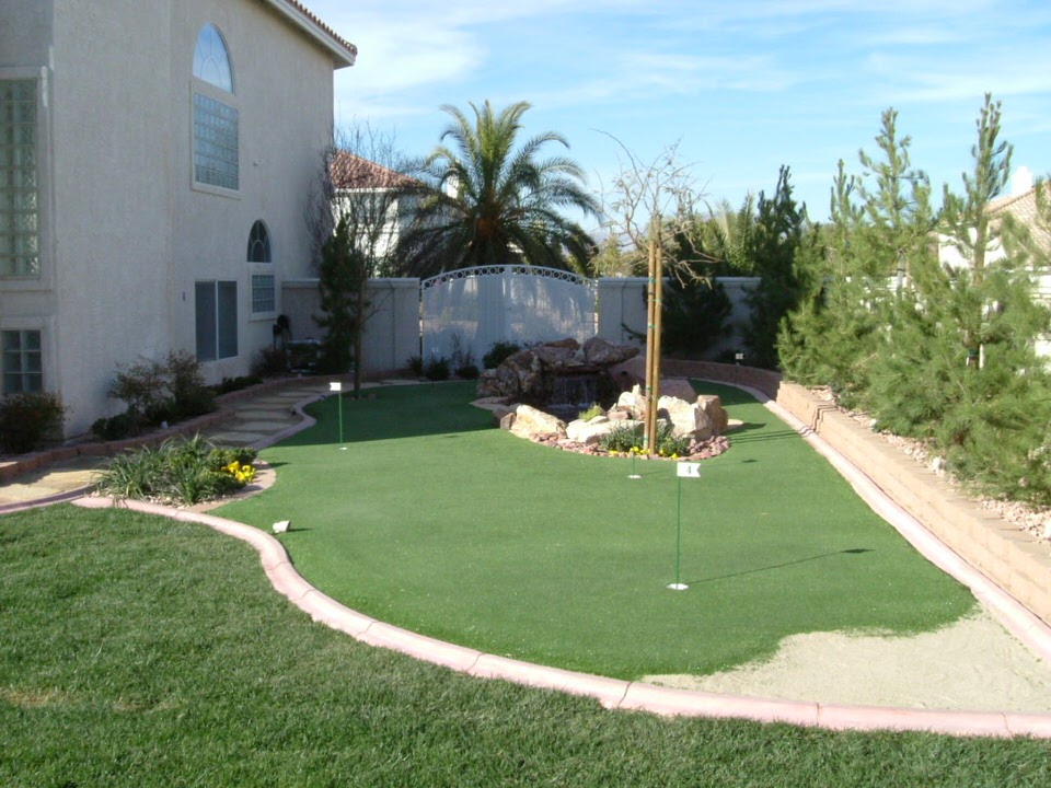 backyard with grass and golf course