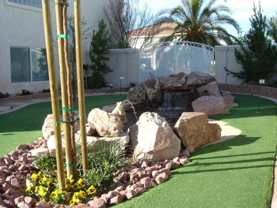 small pond and rocks around a backyard golf course