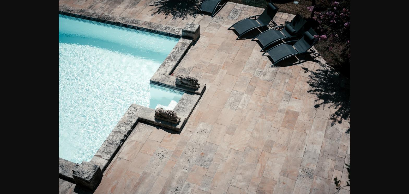 Travertine paver pool patio with lounge chairs in a Las Vegas backyard